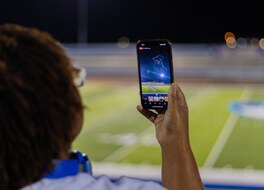 An image of a spectator recording the NLDS Oak Creek National Night Out show from the stadium bleachers.