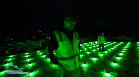 An image of an NLDS groundcrew member setting up drones prior to an event. An image of an NLDS groundcrew member setting up drones prior to an event.