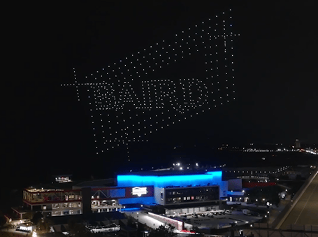 An image from an NLDS drone show featuring a sponsor message above spectators. An image from an NLDS drone show featuring a sponsor message above spectators.