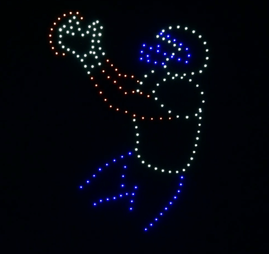 An image from an NLDS drone show featuring a football player diving to catch a ball. An image from an NLDS drone show featuring a football player diving to catch a ball.
