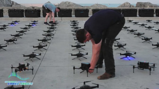 An image from prior to an NLDS drone show featuring the groundcrew members turning the drones on.