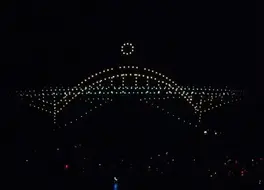 An image from an NLDS drone show featuring a Milwaukee bridge formation over the lakefront. An image from an NLDS drone show featuring a Milwaukee bridge formation over the lakefront.