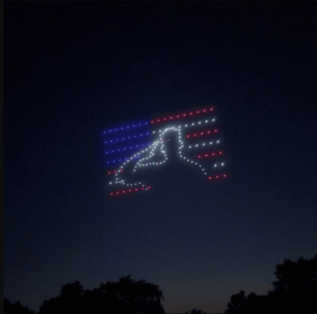 An image from an NLDS drone show featuring a saluting figure wrapped in an American flag that appeared in the NLDS New Berlin Fourth of July show.