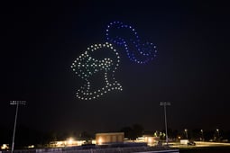 An image from an NLDS drone show flying above the Oak Creek High School football field at the City of Oak Creek National Night Out.