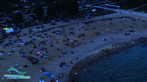 An image depicting spectators gathered to watch an NLDS drone show.