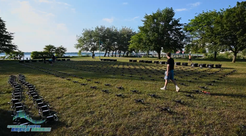 An image from an NLDS drone show depicting a groundcrew member overseeing the set up.