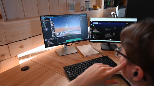 An image of an NLDS designer creating the artwork behind a show.