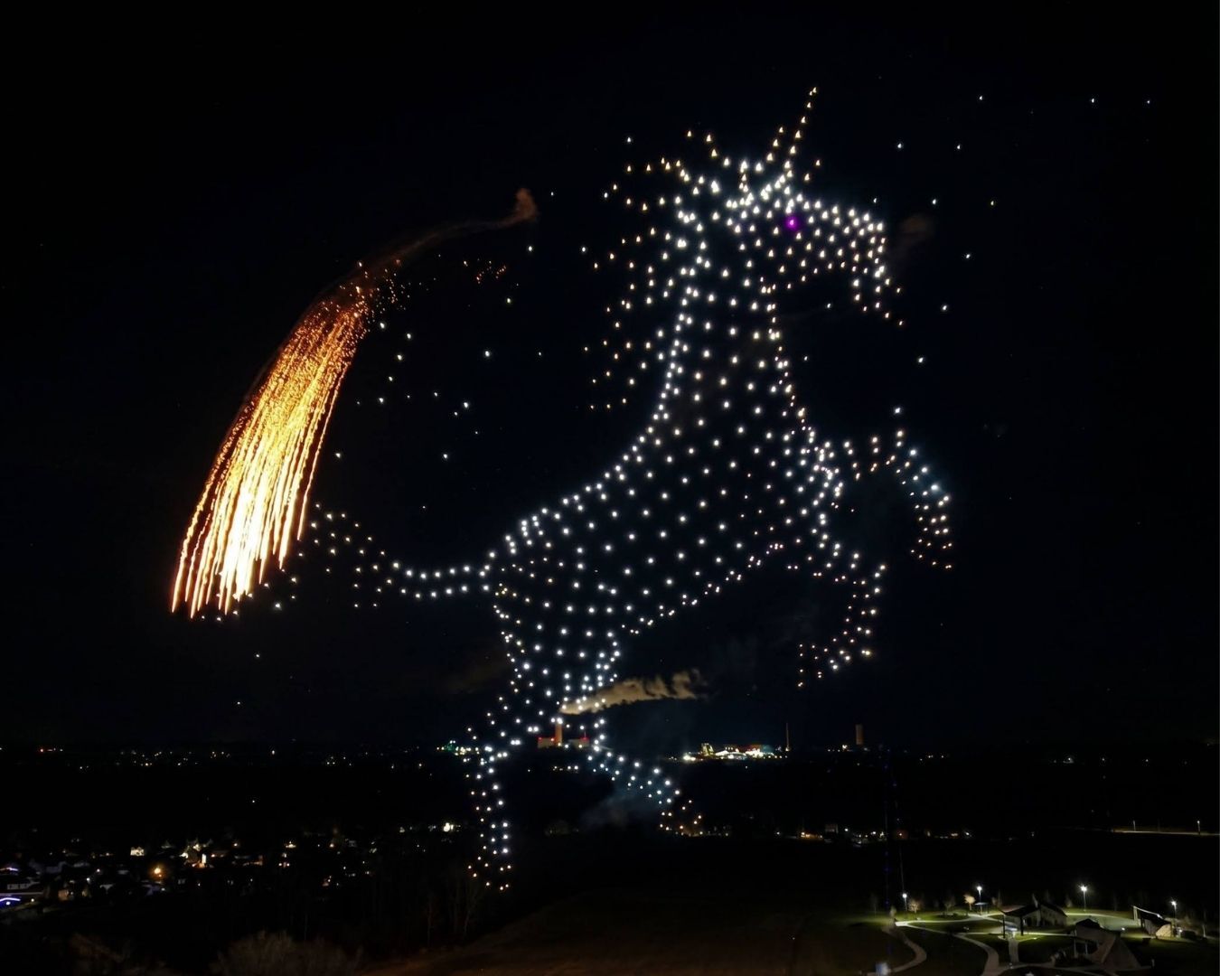 An image from an NLDS drone show depicting a Unicorn with a flaming tail.
