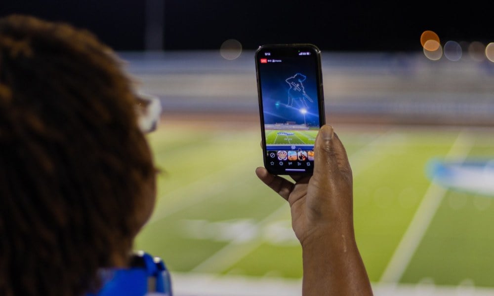 An image of a spectator recording the show on a phone that appeared in the NLDS Oak Creek National Night Out show.