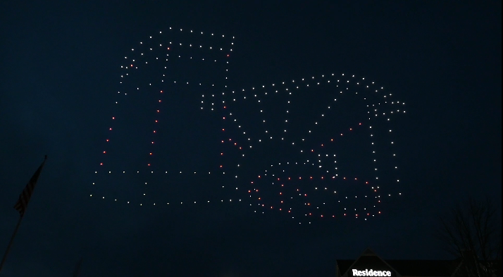An image from an NLDS drone show depicting a car driving through a car wash. An image from an NLDS drone show depicting a car driving through a car wash.