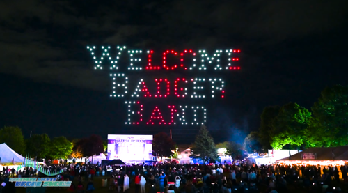 An image for-scale showing how large a sign comprised of drones can be in relation to a crowd of hundreds of spectators. An image for-scale showing how large a sign comprised of drones can be in relation to a crowd of hundreds of spectators.