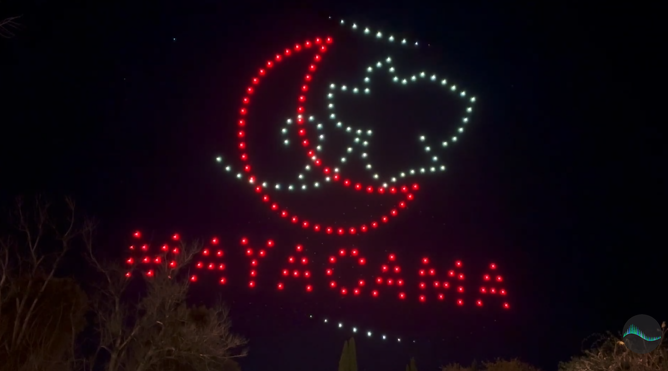 An image of a brand's logo during a sponsor section of a drone show.
