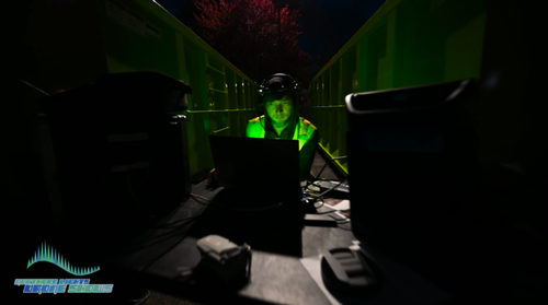 An image from an NLDS drone show showing one of our pilots overseeing a drone show from his control point.