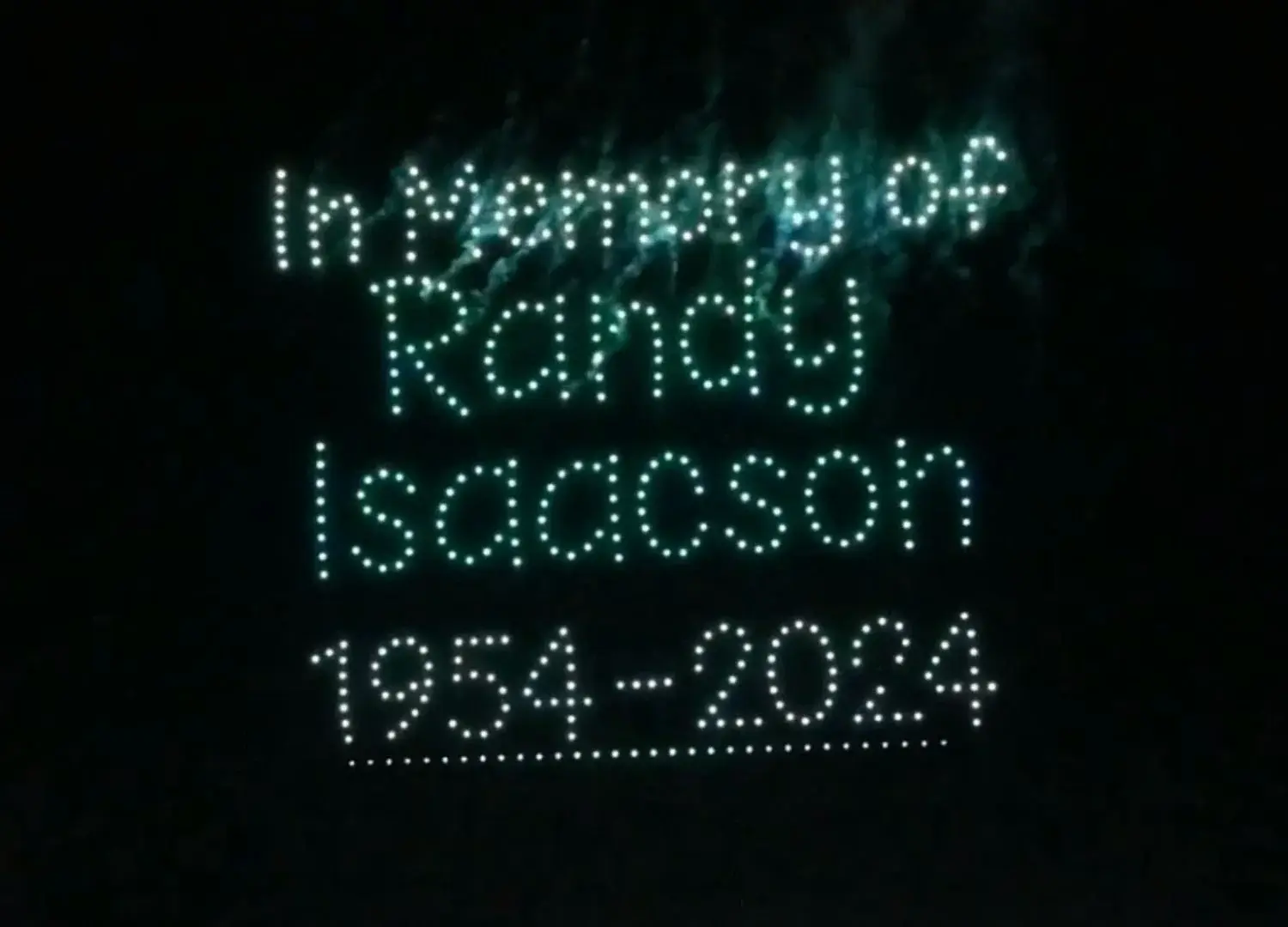An image from the 2025 BCI Grand Opening show featuring an "In Memory" message for Randy Isaacson.