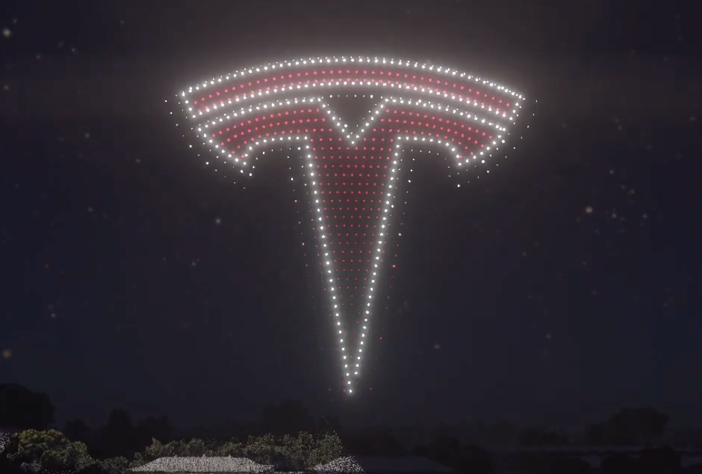 An image from the Silicon Valley Tesla Owners Club show featuring a Tesla logo.